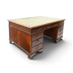 D Matthews & Son Office Furnishers (Liverpool) - Edwardian mahogany twin pedestal partners desk, rectangular top with inset green leather writing surface, fitted with an assortment of twelve drawers with brass swan neck handles, the pedestals with cupboards fitted to the opposing side, raised on ogee bracket feet