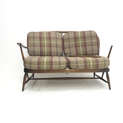 Ercol beech two seat Windsor settee, upholstered back and seat, turned supports, W130cm