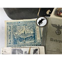 WW2 German War Pass (Wehrpass) identification paperwork for Walter Fensterseifer 2nd type booklet dated 8/6/1940, with signed photo of recipient in civilian suit. Born 31st January 1921. Numerous entries; together with quantity of small private photographs of German soldiers; One Million mark banknote 1923; 30th Corps in Germany booklet with Formation badge; and other WW2 paper ephemera