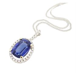 18ct white gold sapphire and diamond halo pendant necklace, single cushion cut sapphire of approx 4.65 carat, with round brilliant cut diamond surround and bail, on fine flattened curb link chain necklace, both hallmarked, total diamond weight approx 0.35 carat