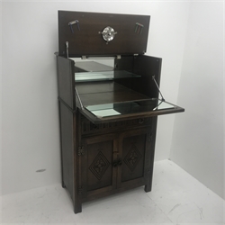 Mid 20th Century oak cocktail cabinet, carved drop front enclosing mirrored interior above single drawer and two cupboards, stile supports, W75cm, H122cm, D43cm