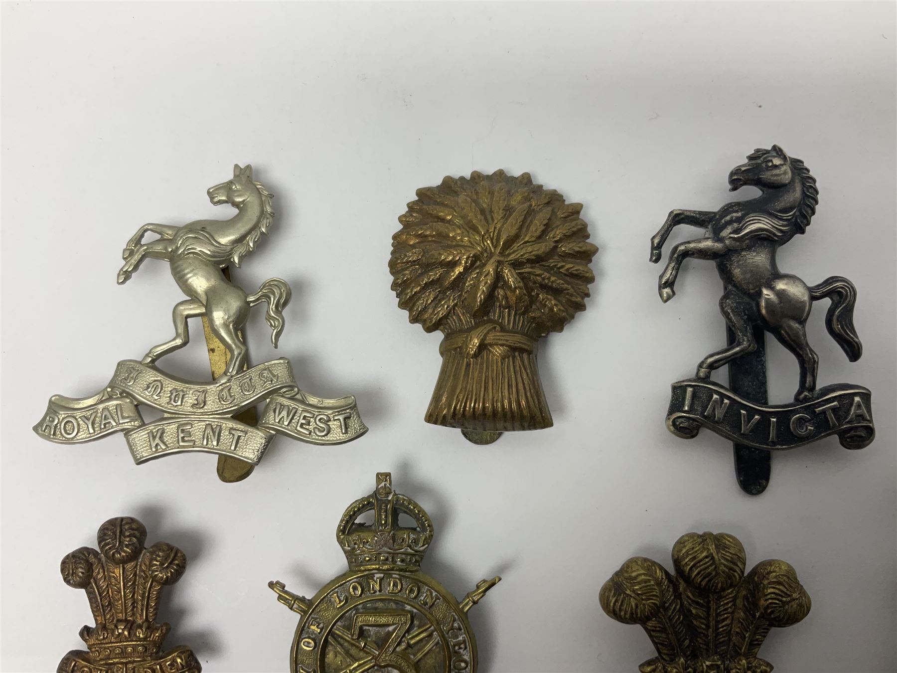 Nineteen Yeomanry metal cap badges including Derbyshire, Northamptonshire, Essex, Glamorgan, Staffordshire, City of London, Surrey, Shropshire, Hertfordshire etc; together with eleven Fusiliers badges including Lancashire, Royal Welch, Northumberland etc (30)