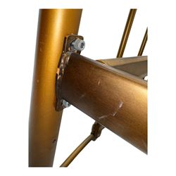 Victorian design king size brass bed frame, featuring an arched headboard and footboard with intricate cast floral and scrollwork centre motifs, flanked by cylindrical supports with ball finials and decorative collars, raised on rounded feet, with a slatted wooden base