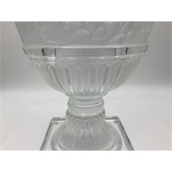 Large and impressive Lalique Versailles pattern glass vase, of classical baluster form with gadrooned flared rim, the body moulded in relief with fruiting vines above part fluting, upon a spreading circular foot with moulded decoration, and plain square plinth base, signed Lalique France to side of plinth, overall H35cm, with original box 