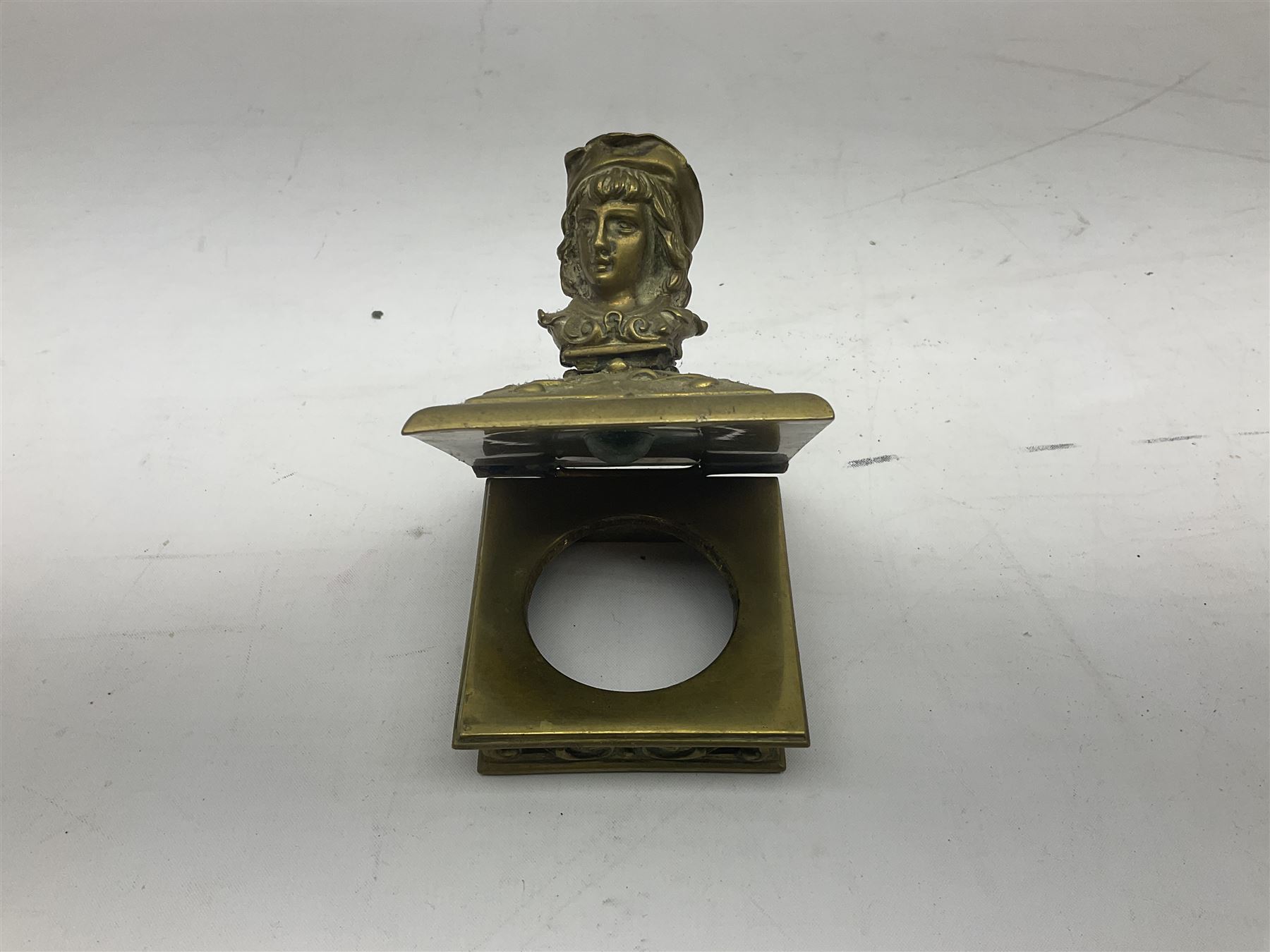 Collection of victorian and later brass desk accessories, to include a letter holder with cherub design, ink well of square form with hinged lid, brass table bell, brass casket with relief decoration, etc  