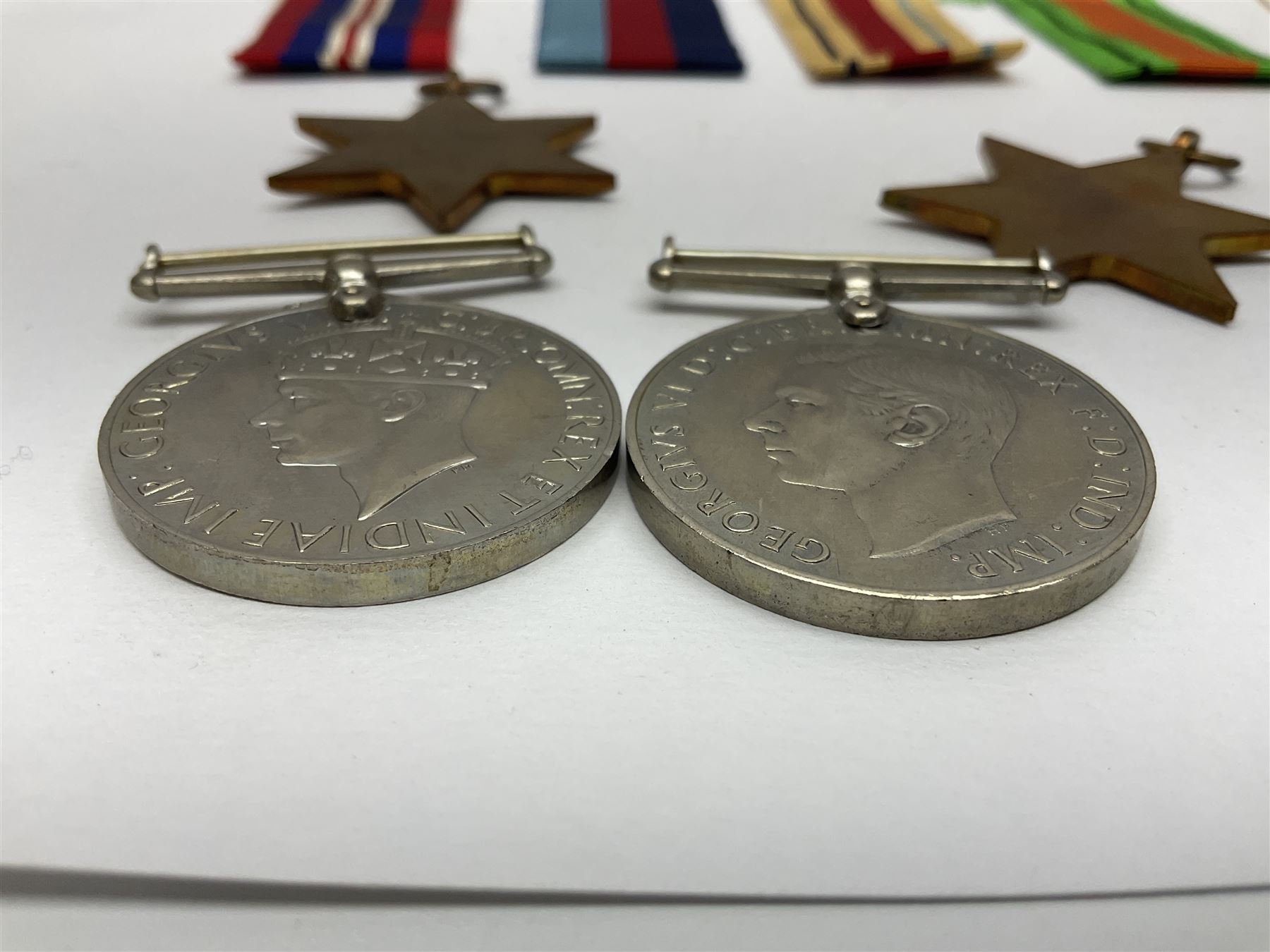 Twelve WW2 medals comprising four 1939-1945 war medals, four Defence medals, three 1939-1945 Stars and Africa Star; all with ribbons; some as groups in two issue boxes with slips