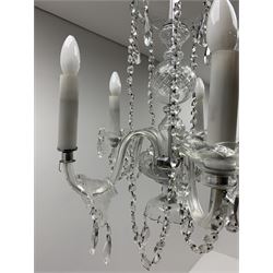 A glass chandelier, with five curved branches with drip pans and droppers, approximately H69cm. 