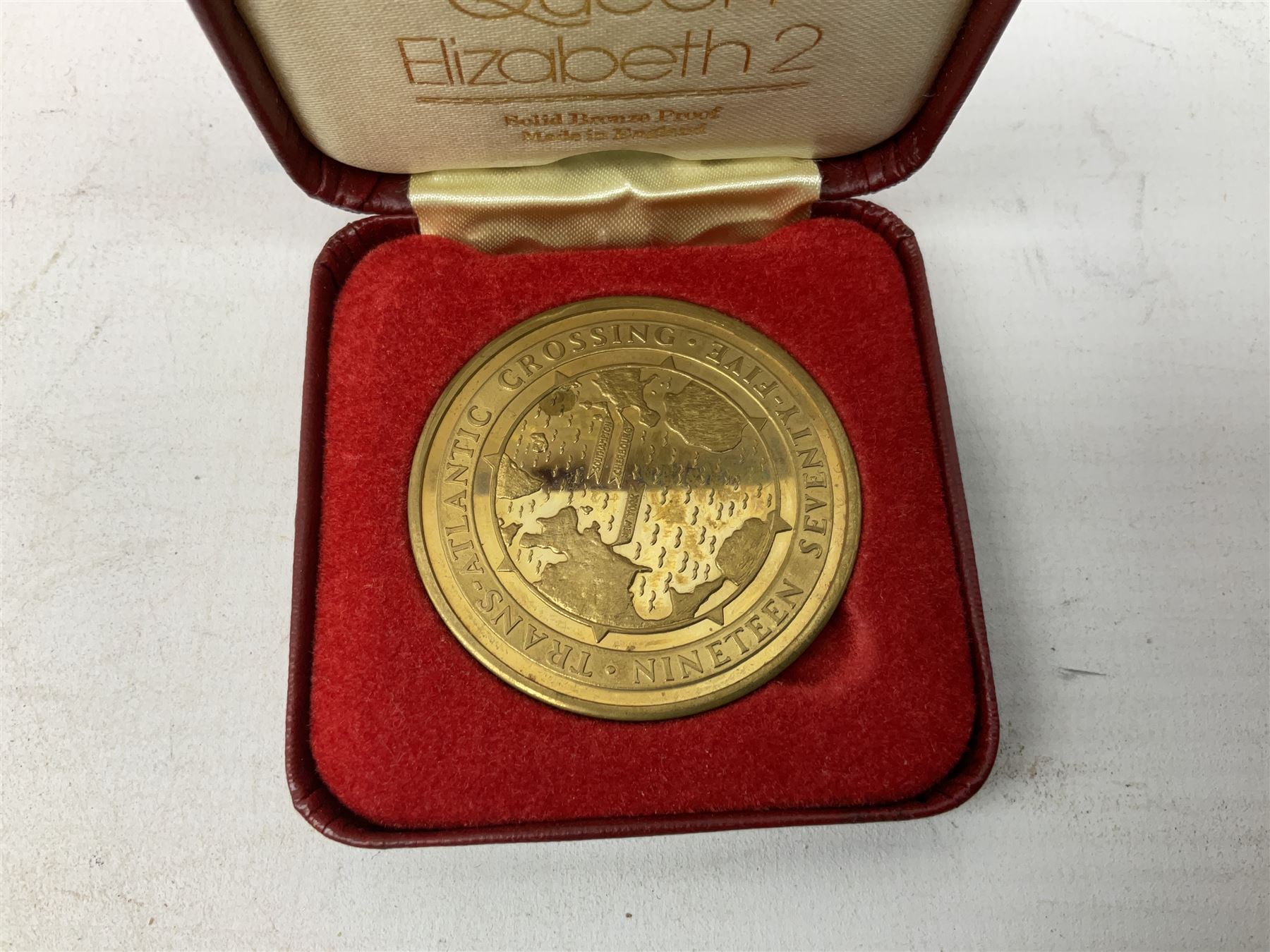 Queen Elizabeth II cradle of civilization cruise 1976 bronze medallion with related book and two other Queen Elizabeth II commemorative medallions for cruises in 1975 and 1976, all cased