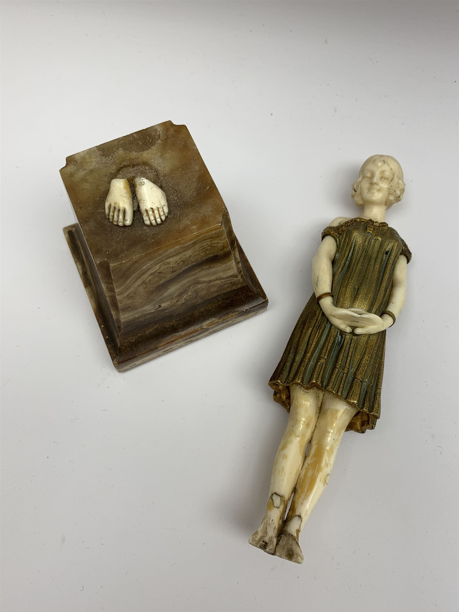 Demetre Chiparus (1886-1947): Innocence, a gilt bronze and ivory figure, circa 1925, standing in contemplative post with hands clasped, upon onyx plinth, signed to base, H24.4cm