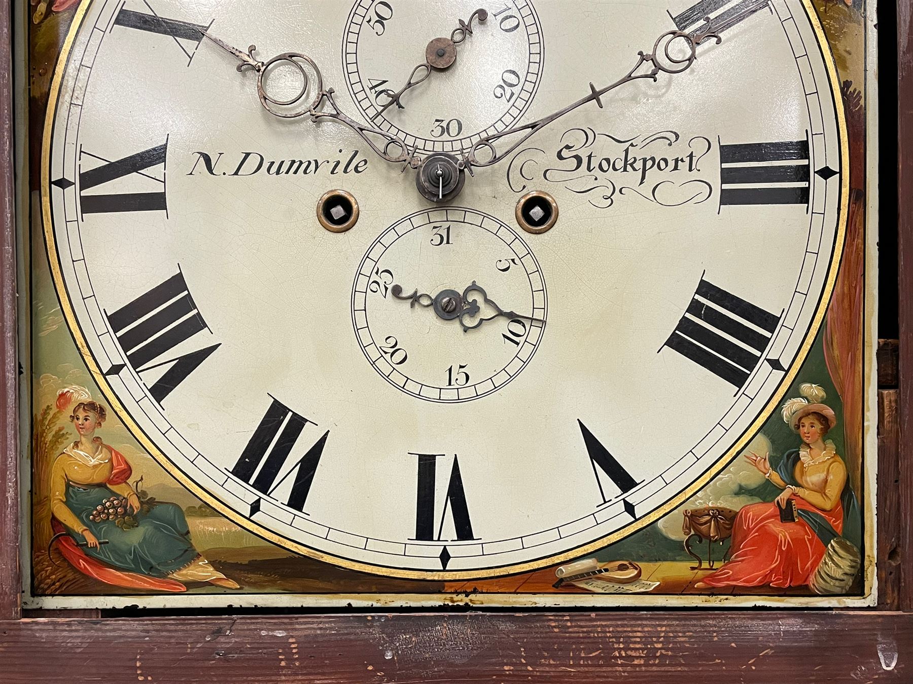 Nathaniel Dumville of Stockport - 8-day brass inlaid mahogany longcase clock c1840, swans neck pediment with ball and spire finials and wooden paterae, recessed break arch hood door flanked by rope twist pilasters, trunk with conforming pilasters and gothic ogee topped door, canted plinth raised on bracket feet, fully painted break arch dial with moon work and spandrels depicting the four seasons, centre with Roman numerals, minute track, subsidiary date and seconds dials, matching stamped brass hands, four pillar movement with an anchor escapement, rack striking on a bell. With weights and pendulum.
The Dumville family were prevalent Cheshire clockmakers working in Stockport 1820-42.
