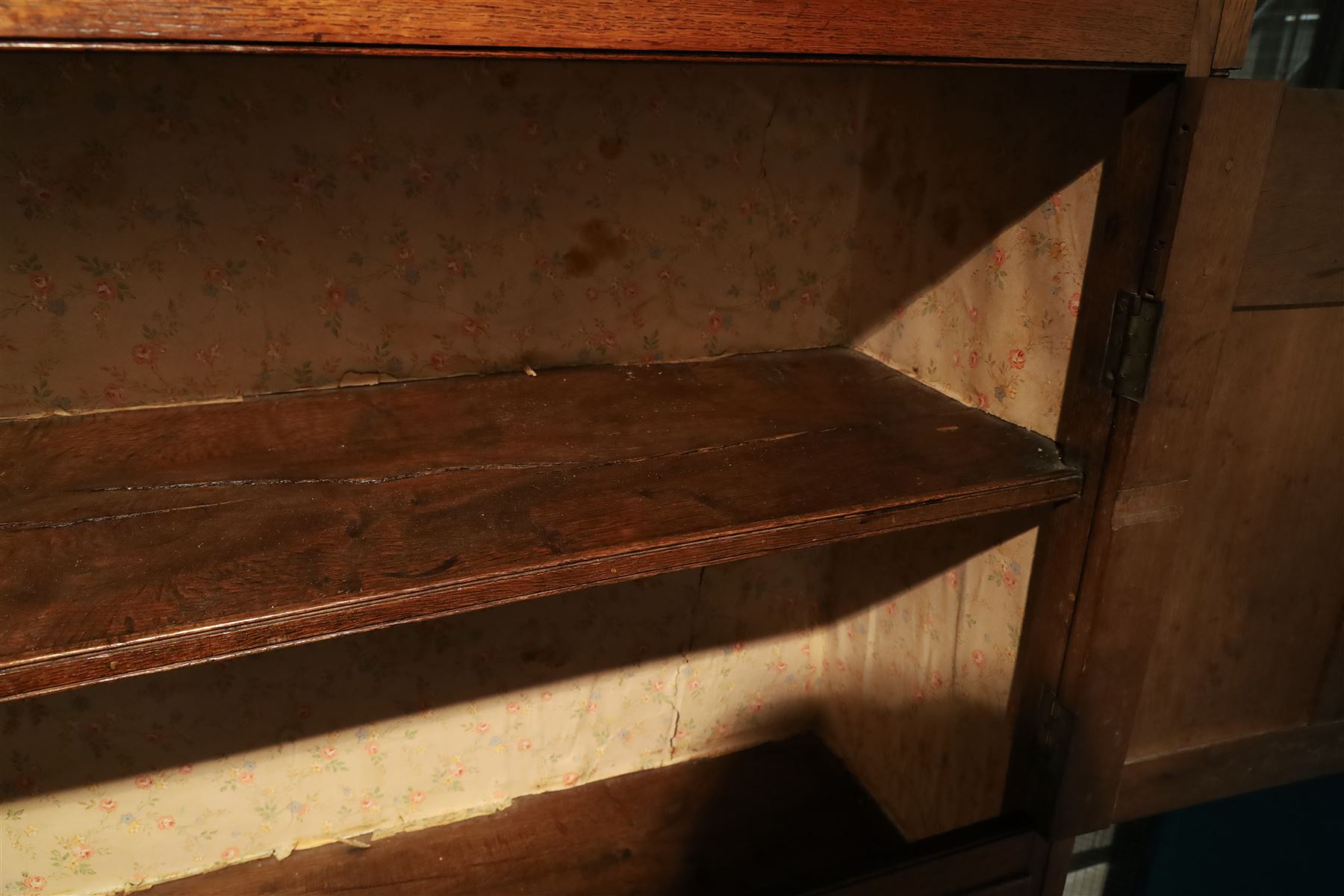 18th century oak larder cupboard, projecting moulded cornice over two panelled doors with shaped arched fielded panels, three short dummy drawers above base fitted with two short and one long drawer, turned handles, on bracket feet