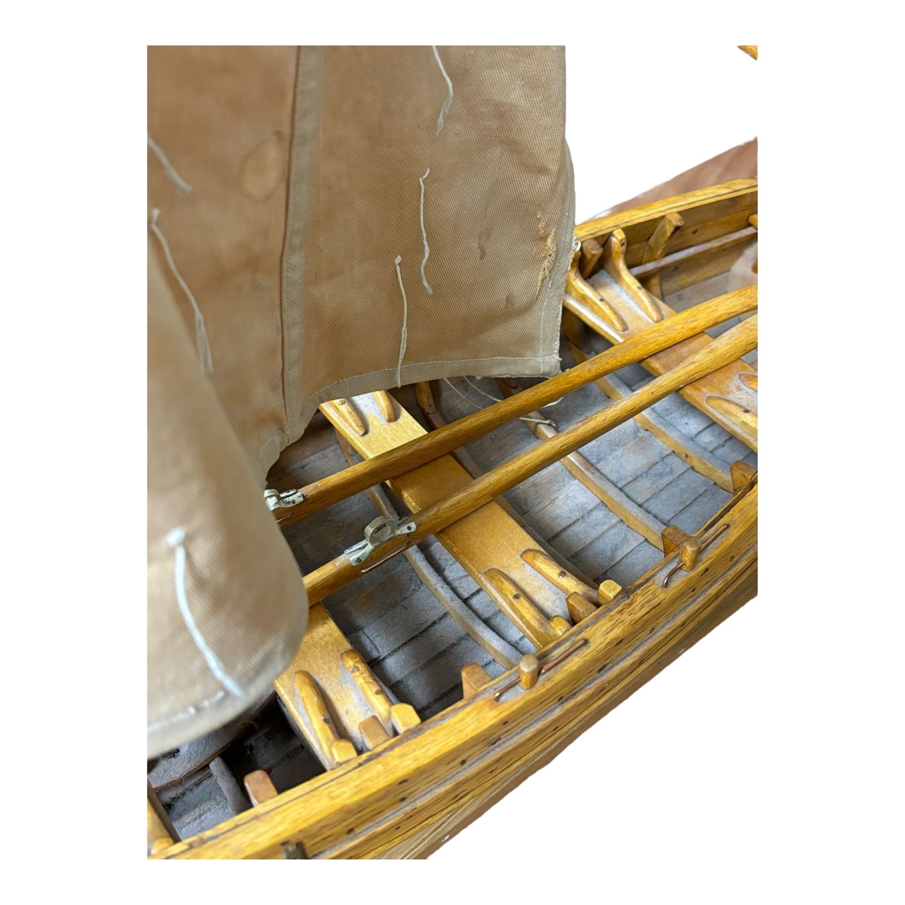 Wooden model of a fishing coble, with single canvas sail, upon a rectangular wooden plinth, total H74cm