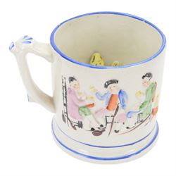 19th century frog and newt cup, decorated with a house in a landscape and cows, featuring a frog and newt inside the cup, together with three other frog cups 