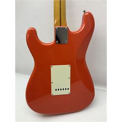Japanese Squier Fender 'Hank Marvin' Stratocaster electric guitar, c1992, in Fiesta red with tremolo arm and facsimile signature decal; serial no.L037281, L98cm; in hard carrying case.