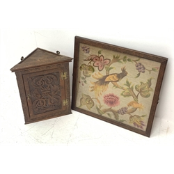 19th century needlework and plushwork picture depicting an exotic bird set on a naturalistic branch formed of tapestry with wool-pile flowers within an a glazed oak frame, 57cm x 56cm and a small carved corner cupboard (2)