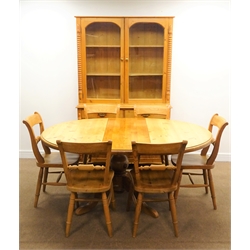  Solid pine circular extending dining table, single column support on four shaped feet (W129cm, H76cm, D170cm) with six chairs and pine dresser, two doors enclosing shelves, two drawers and cupboards, turned supports (W123cm, H193cm, D45cm)  