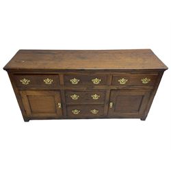 George III country oak dresser base,  rectangular top over with three central drawers flanked by two drawers and two panelled cupboards, each with moulded fronts, on stile feet