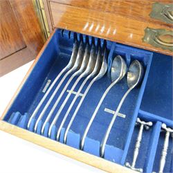 Oak table top canteen cabinet, the top with inset vacant brass cartouche, with pair of panelled doors opening to reveal four interior drawers with inset brass handle, containing a selection of silver plated flatware, 29cm x 40cm x 51cm