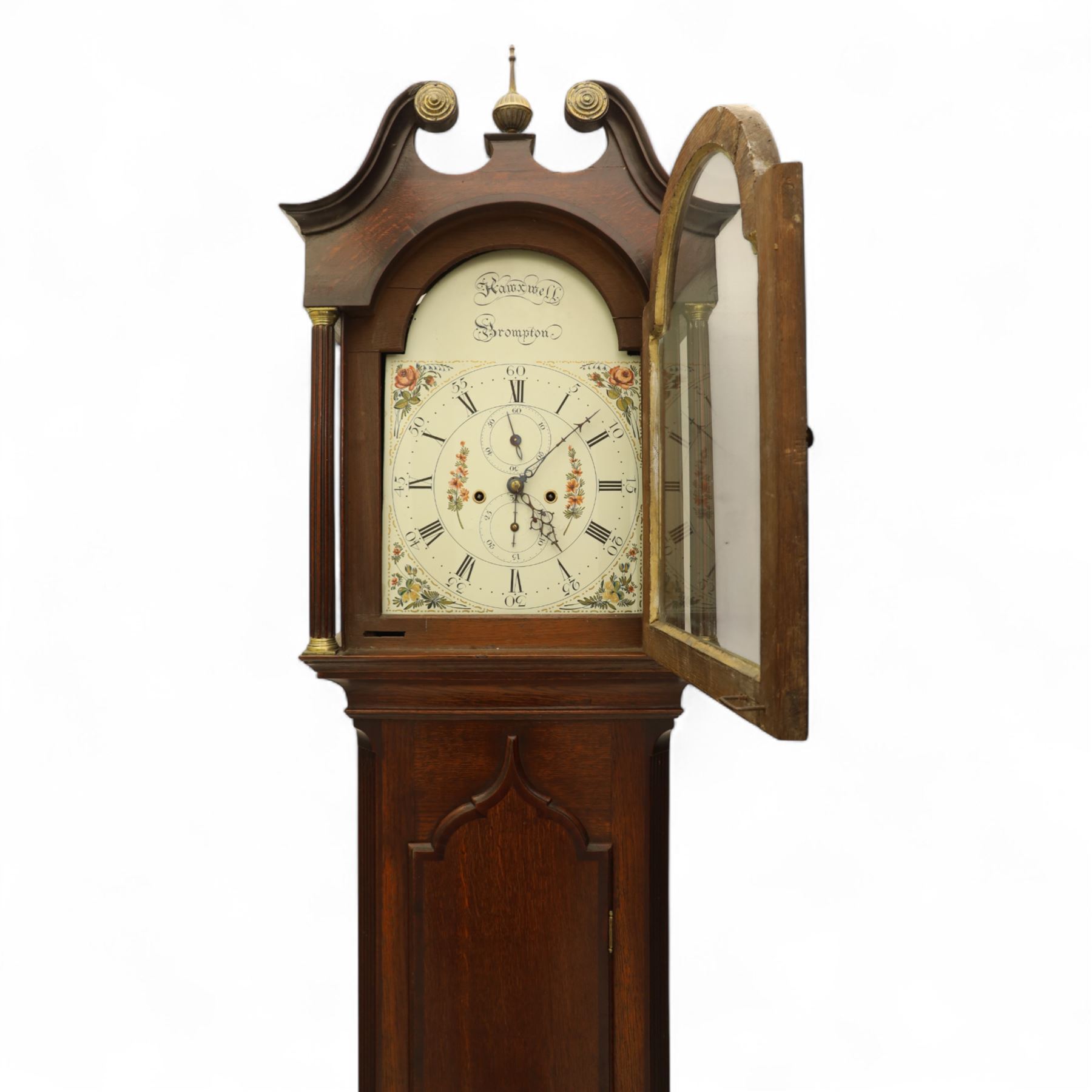 Thomas Hawkswell of Brompton (Nr Pickering-Yorks), 8-day oak cased longcase clock with a swan necked pediment and central brass finial, break arch hood door flanked by reeded pilasters with brass capitals, trunk with canted corners and a spire topped door, square plinth raised on a shaped skirting, painted dial with floral spandrels and makers name to the arch, with Roman numerals, calendar and seconds dial and pierced steel hands, dial pinned to a twin train rack striking movement, striking the hours on a bell. With weights and pendulum.