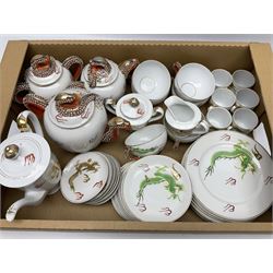 Mid 20th century Japanese tea service for six, all decorated with moulded dragons with gilt detailing, the teacups base having lithophane of a geisha girl, to include plates, teacups and saucers, coffee cans and saucers, teapot, coffee pot, twin handled lidded sucrier etc