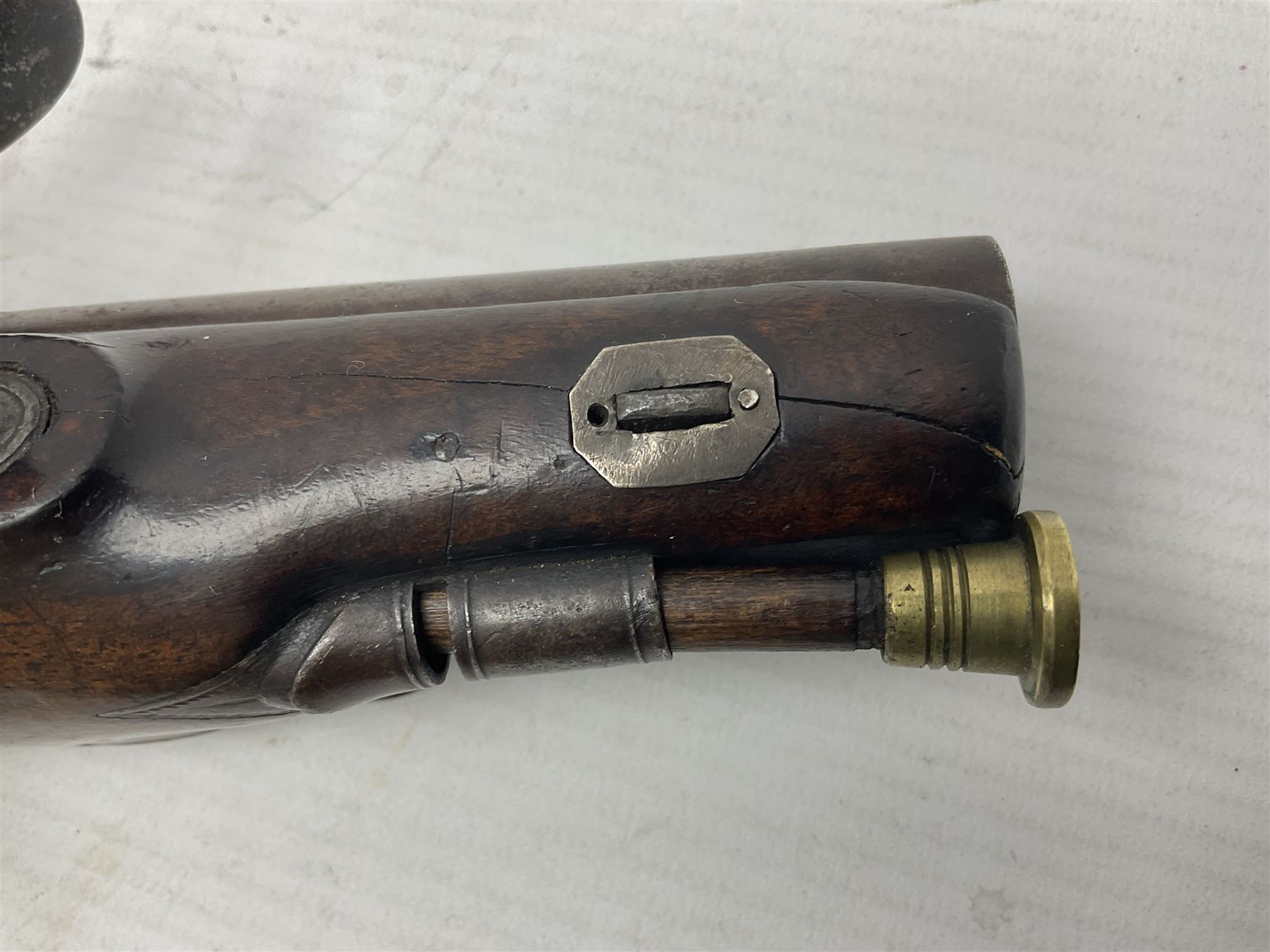 Early 19th century Wm. Hollis flintlock belt or pocket pistol, approximately 20 bore, the 10cm barrel with ram rod under, engraved lock plate with maker's name and roller frizzen, engraved trigger guard with pineapple finial and walnut stock with chequered grip L25cm overall