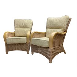 Contemporary rattan conservatory suite - two seat sofa with wicker frame and loose cushions upholstered in textured champagne fabric (W125cm H98cm); pair of matching armchairs (W72cm H98cm); rectangular glass-topped coffee table with rattan frame and undertier (W85cm D60cm H47cm); and matching square side table (W53cm H55cm)