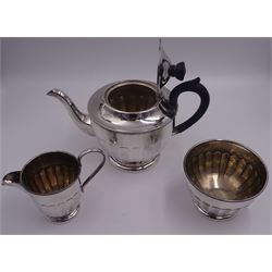 1930's silver three piece bachelors tea service, comprising teapot with ebonised handle and finial, milk jug and footed sugar bowl, each of part fluted footed form, hallmarked Viner's Ltd Sheffield 1936, approximate gross weight 25.12 ozt (781.4 grams)