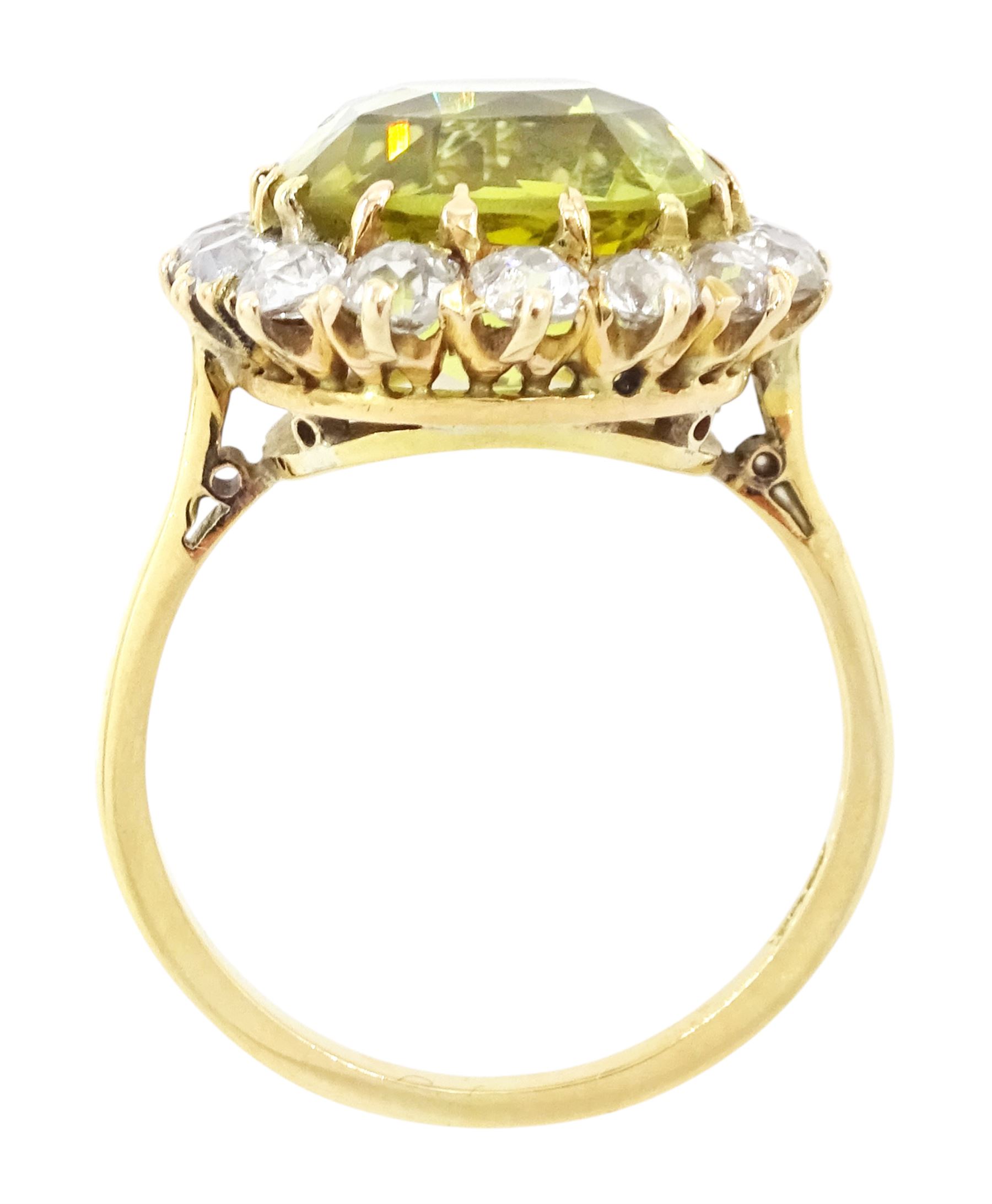 Early 20th century gold chrysoberyl and diamond cluster ring, single cushion cut yellow / green chrysoberyl of approx 8.00 carat, surrounded by sixteen old cut diamonds, stamped 18ct, total diamond weight approx 1.10 carat