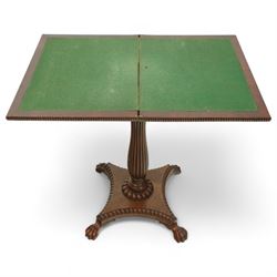 William IV mahogany folding card table of unusually small proportions, rectangular swivel top with gadrooned edge, raised on a slender tapered reeded column over quatreform base with gadrooned border, terminating in carved lion paws feet