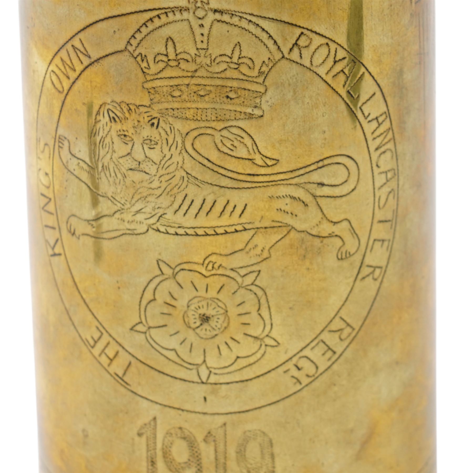 First World War trench art shell casing, decorated with crest for The Kings Own Royal Lancaster Regiment, one side decorated with detailed portrait; together with Two Victorian Brass finger plates together with a brass badger and a saussurite model of a pig