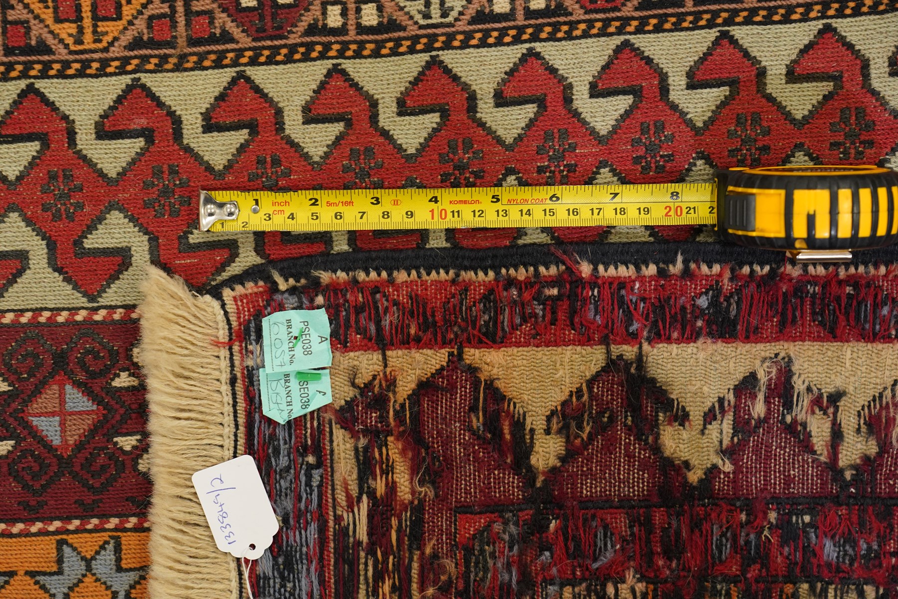 
Oman tribal design rug, field decorated with horizontal bands of stylised birds, flowerheads, stars and hooked geometric motifs in red, ivory, ochre and pale blue, enclosed by serrated ivory and red borders and narrow patterned guard stripes