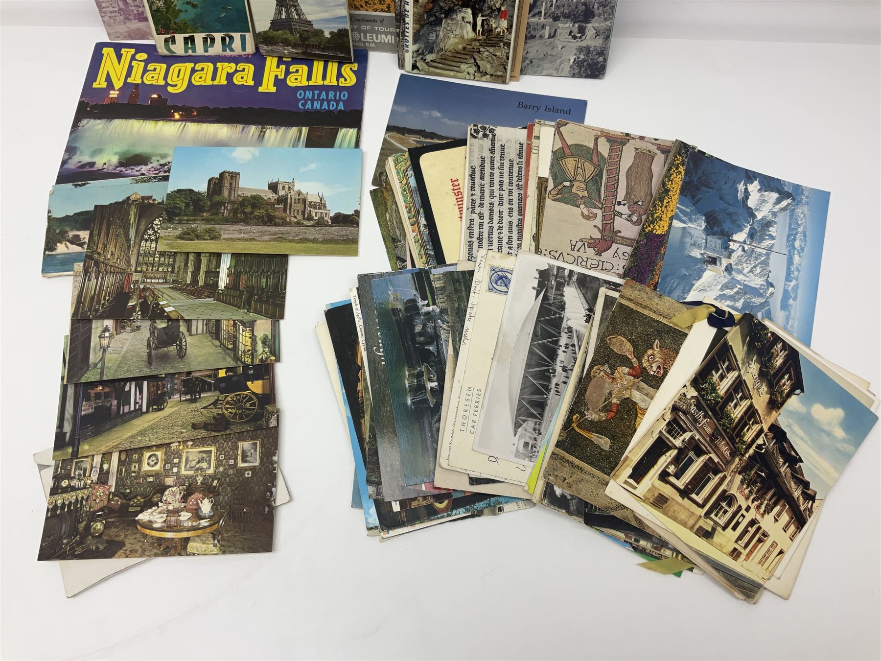 Seven pen knives, two lighters, including one Ronson example and a collection of postcards