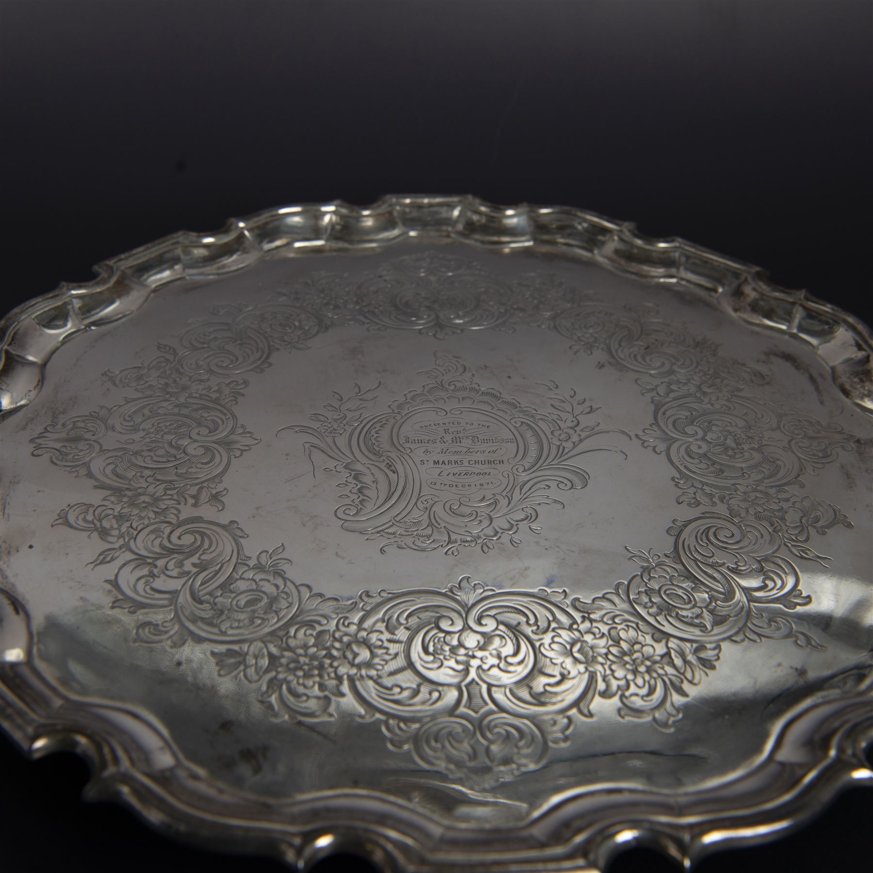 George II silver salver, of circular form with pie crust rim, with later floral and foliate decoration and presentation engraving to centre, upon three stepped feet, hallmarked William Peaston, London 1749, D30cm
