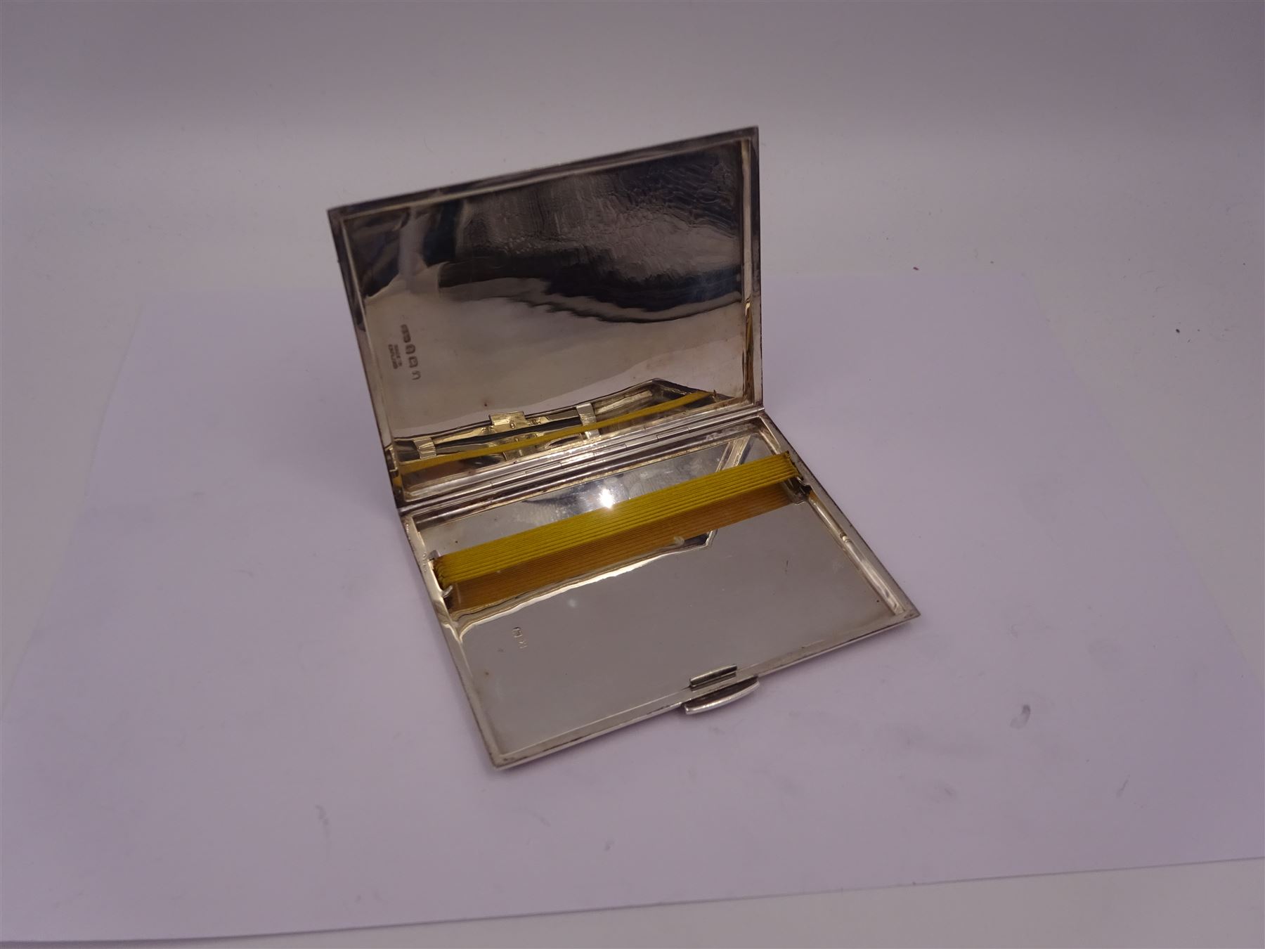 Mid 20th century silver cigarette case, of rectangular form with geometric engraved decoration, hallmarked Dudley Russell Howitt, Birmingham 1947, H8.5cm