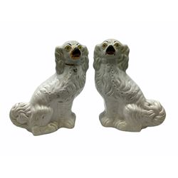 A pair of large 19th century Staffordshire dogs with glass eyes, H31cm, together with another smaller pair, H28cm, each in the form of a spaniel with white coats. 