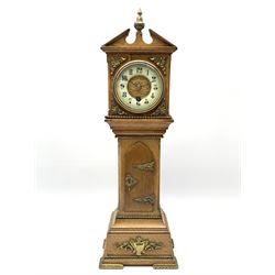 Late 19th century oak miniature longcase timepiece clock, sloped pediment with central finial, circular enamel Arabic chapter ring, single train driven movement, the trunk with a pointed arched door, on stepped moulded base, decorated with applied gilt metal beading and ornate mounts