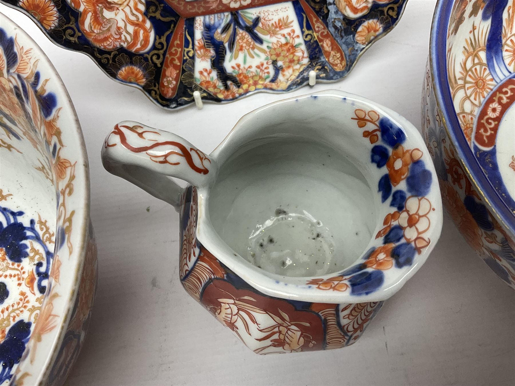 Two Japanese Imari bowls, together with Imari dish with scalloped edge and jug, largest bowl, H12cm