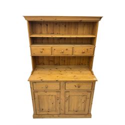 Solid pine dresser, raised plate rack with three drawers, above two drawers and two cupboards