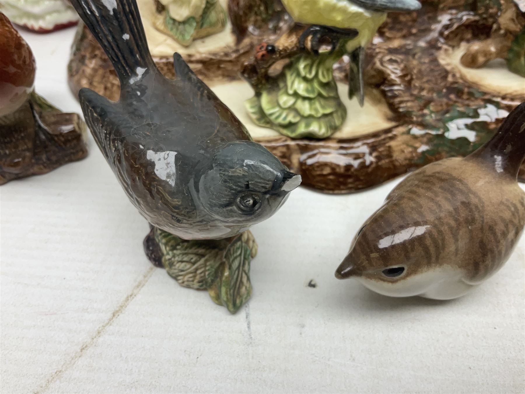 Nine Beswick bird figures, with stand, together with USSR thrush, two Franklin Mint Jane Austin figures and four Royal Doulton figures 