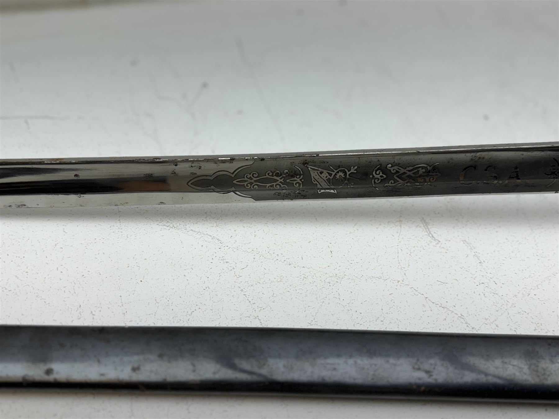 Replica Confederate States Army officer's sword, with brass pommel, black leather hand grip, the 85cm single edged blade marked CSA, in a metal and brass scabbard, L106cm