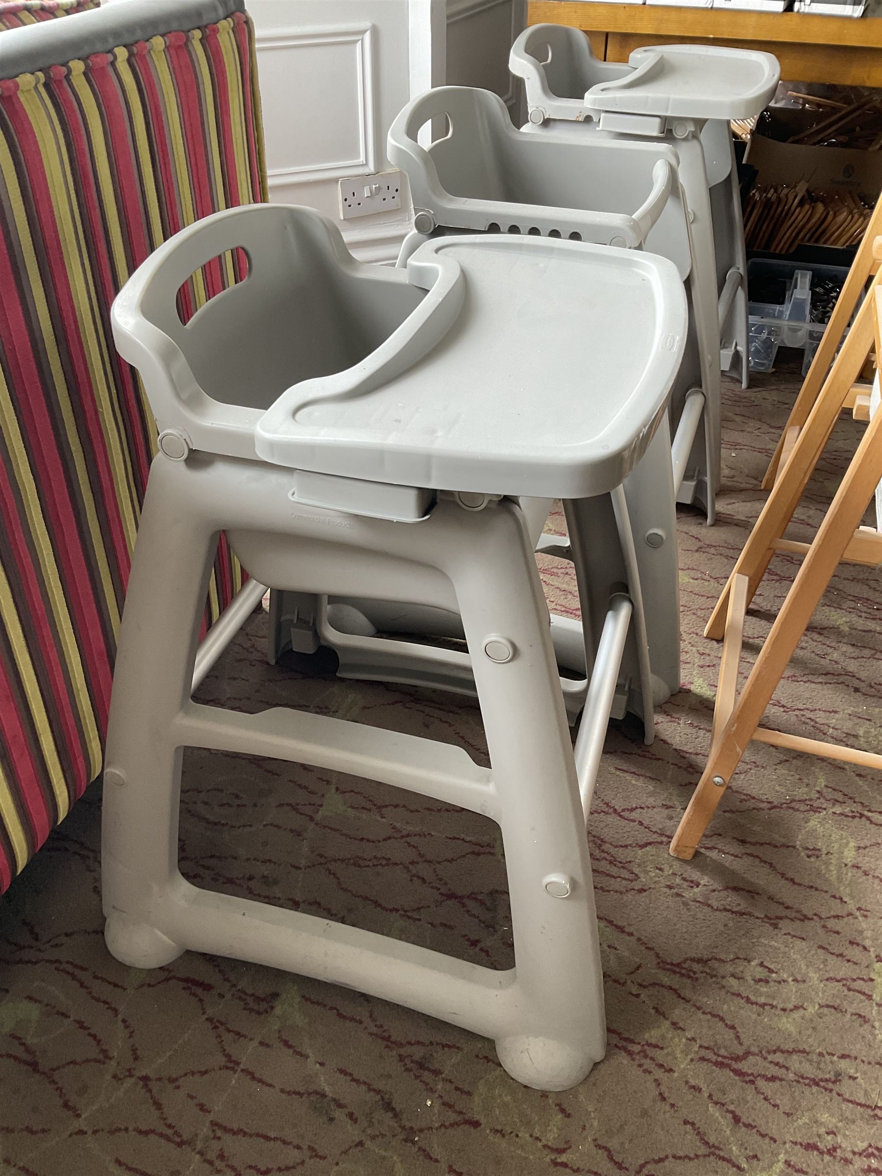 Set of three plastic and a pair of wooden baby high chairs with additional saddle stools (9)- LOT SUBJECT TO VAT ON THE HAMMER PRICE - To be collected by appointment from The Ambassador Hotel, 36-38 Esplanade, Scarborough YO11 2AY. ALL GOODS MUST BE REMOVED BY WEDNESDAY 15TH JUNE.