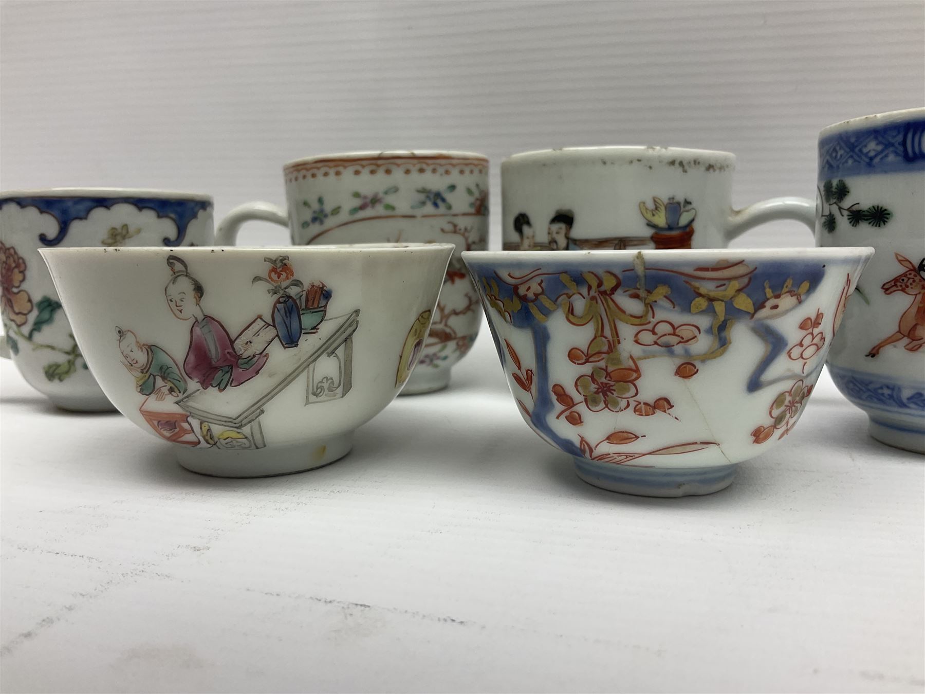 Two 18th century Chinese Yongzheng coffee cups, the first example decorated in polychrome enamel with rooster amidst blossoming peonies, the second decorated with deer and crane among rockwork and pine tree, together with two further 18th century Chinese coffee cups, an 18th century Chinese tea bowl, and a further tea bowl