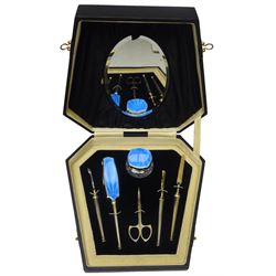 Art Deco thirteen piece silver mounted blue guilloche enamel dressing table set, comprising two hair brushes, two clothes brushes, hand mirror, two cut glass jars, buffer and a cut glass scent bottle, hallmarked J W Tiptaft & Son Ltd, Birmingham 1930 and 1932, and a silver handled manicure set, hallmarked Daniel Manufacturing Company, Birmingham 1930, with a pair of base metal scissors, each contained within three original fitted cases with black and cream silk and velvet lined interiors, one with removable mirror