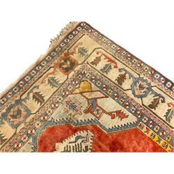 Anatolian Turkish ivory ground carpet, the central geometric pole medallion within an amber field, the guarded border decorated with stylised plant motifs surrounded by bands of repeating flower heads