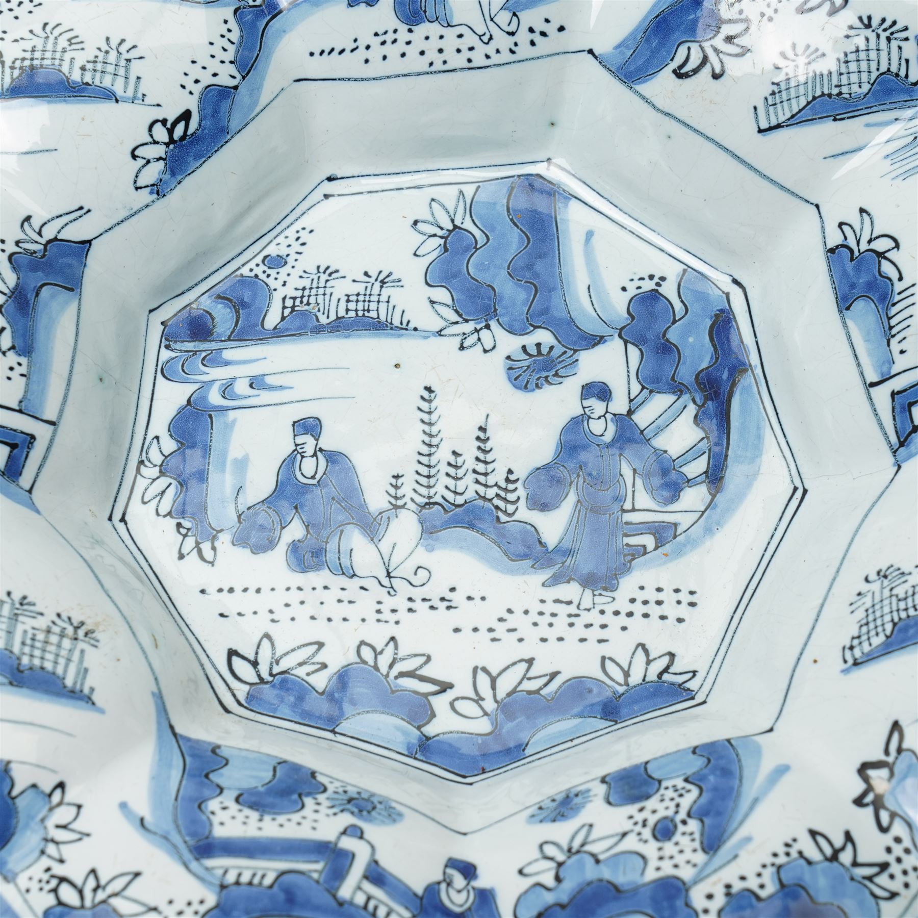 Early 18th century Frankfurt tin glazed earthenware shallow dish decorated in blue with panels of Chinese figures and landscapes D34cm