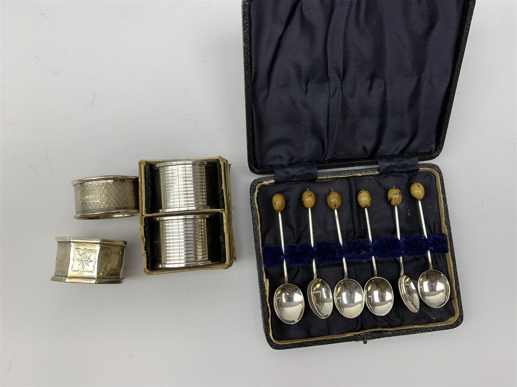 Two silver napkin rings by Collingwood & Sons Ltd, Birmingham 1928 and two other silver napkin rings hallmarked, approx 3.2oz, cased set of silver silver handled knives, hallmarked Sheffield 1915, together with a selection of silver plated flatware, to include Walker and Hall fish eaters set, cased nut cracker set with grape scissors, etc., plus a silver mounted hair brush and hand held mirror, hallmarked Chester 1919