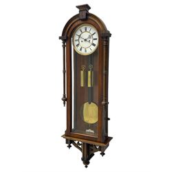 Lenzkirch – 8-day walnut cased weight driven Vienna regulator manufactured 1877-1878, with a break-arch pediment surmounted by a turned finial on a raised cavetto molding, fully glazed arched  door flanked by long ring turned pendants, flat base with open fretwork and two short pendants,  two piece enamel dial within a brass slip, Roman numerals, minute track and pierced steel hands, wooden pendulum with a brass faced bob, two brass cased weights and pulleys, dead beat escapement with a rack striking movement sounding the hours and half hours on a coiled gong, movement serial number 421410. 
Lenzkirch were one of Germanys most highly respected clock manufacturers of the 19th century, founded in the late 1850s the company produced movements and cases of high quality up until 1932.
