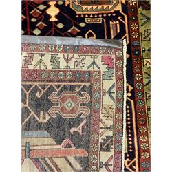 North West Persian Heriz Kelleh rug, the blue ground field with large stylised plant medallions, decorated with flower head, bird and tree of life motifs, triple band foliate pattern borders 