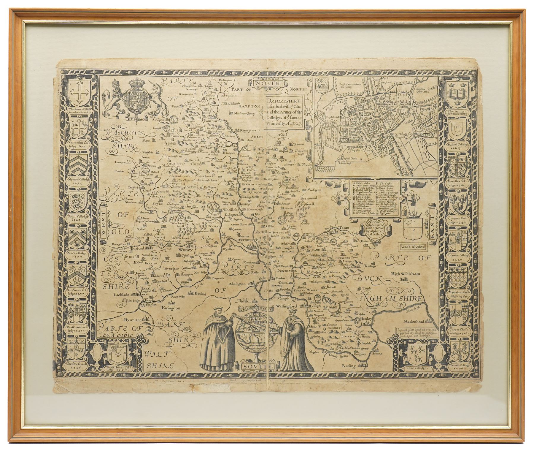 John Speed (British 1552-1629): 'Oxfordshire described with ye Citie and the Armes of the Colledges of ye famous University', 17th century first edition engraved map uncoloured with inset town plan of Oxford and margins decorated with eighteen heraldic shields pub. John Sudbury and George Humble c.1611, with margins, 41cm x 54cm