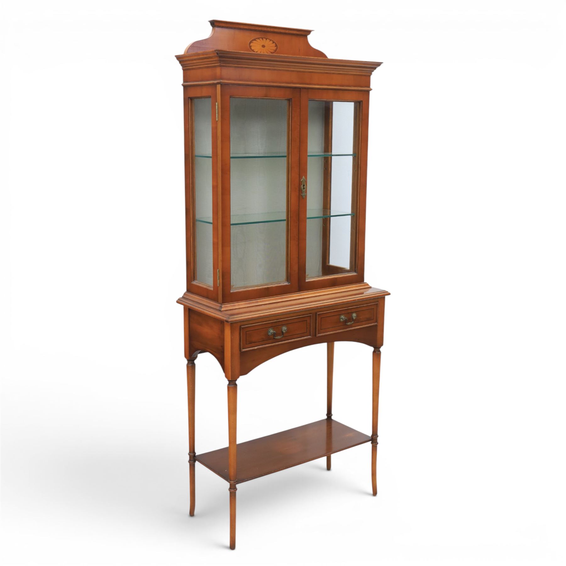 Sheraton design yew wood cabinet on stand, fitted with two glazed doors and two drawers, with lower shelf, illuminated interior